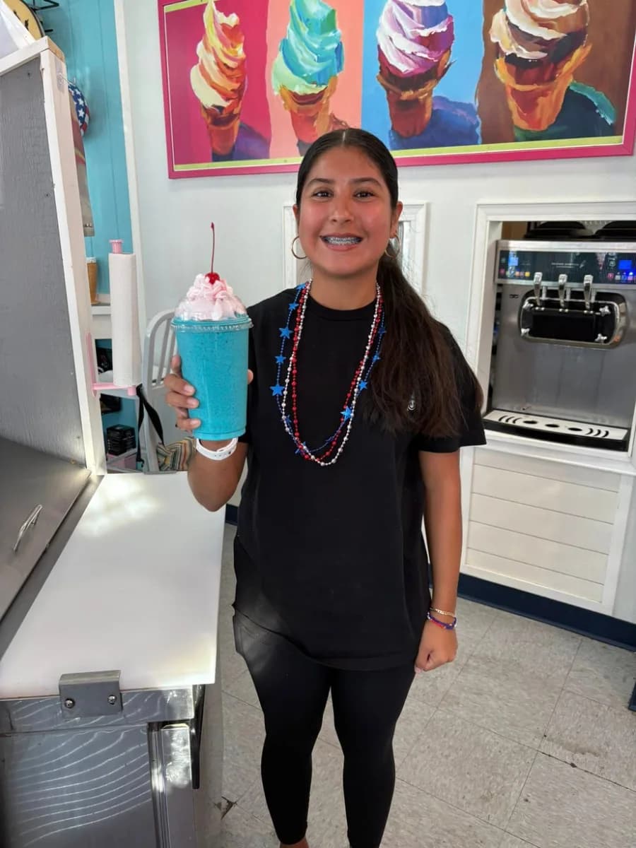 A guest holding a bright blue slushie