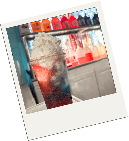 A layered red, white, and blue slushie in a cup